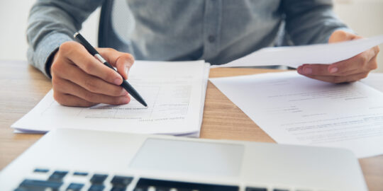 Businessman checking documents at table